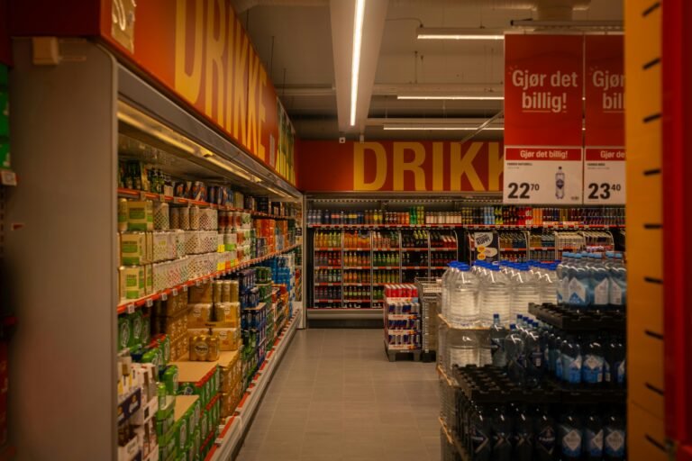 Home Colorful drink aisle in a supermarket with signage promoting deals.